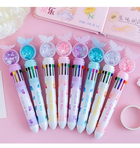 Detail of 10-color shuttle pens with butterfly sequin toppers and pastel macaron barrels