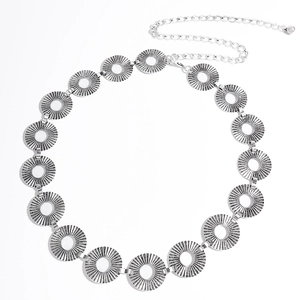 Close-up of vintage silver belt chain featuring hollow radial sunburst metal disks