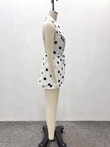 Detail of white polka dot top showing side tie design and premium cotton linen texture