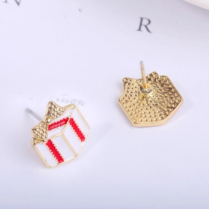 Macro view of Christmas gift box stud earrings showing gold finish and intricate details