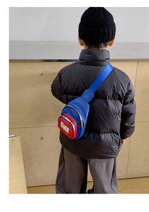 Detail showing the adjustable blue nylon strap and dual-zipper layers on the kids chest bag