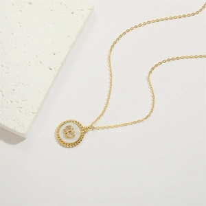 Detail of 14K gold plated necklace with shell butterfly pendant and sparkling zircon stones