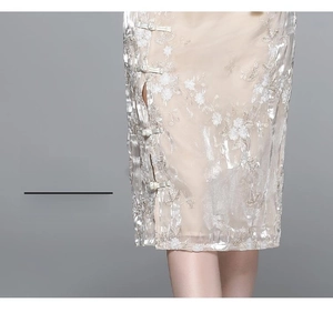 Detail of sequined champagne skirt with 3D floral embroidery and stylish side slit design