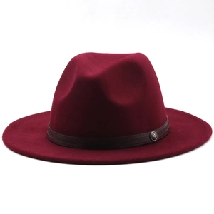 Detail of burgundy wide-brim wool fedora with brown leather band and silver buckle