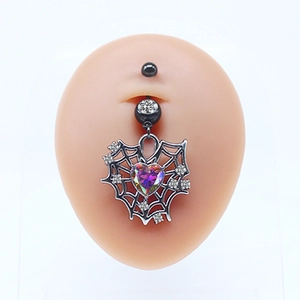 Macro detail of heart-shaped spider web navel ring with iridescent rhinestone and crystals