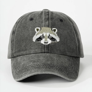 Close-up of raccoon embroidery on washed cotton fabric of the vintage baseball cap