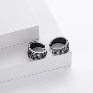 Close-up of black 925 sterling silver hoop earrings with pave-set zircon stones