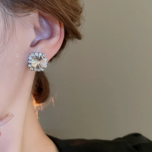 Close-up of model wearing square cubic zirconia silver earrings with sparkling stones
