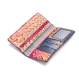 Detail view of colorful crocodile-embossed leather wallet with multiple card slots