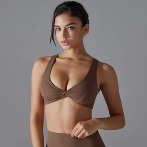 Close-up of brown sports bra featuring a twisted knot front and matte high-stretch fabric