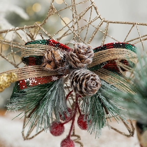 Golden wire Christmas tree topper star with rustic plaid bow and pine cones