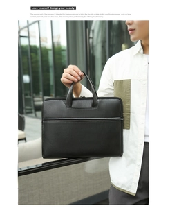Business professional holding a black leather laptop bag in a modern city setting