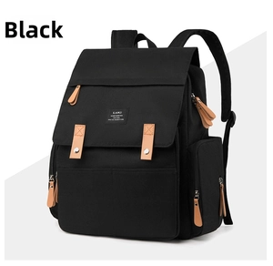 Detail view of the black diaper backpack showing side pockets and padded shoulder straps