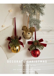 Detail of Christmas metal bells with velvet bows, pine needles and natural cones