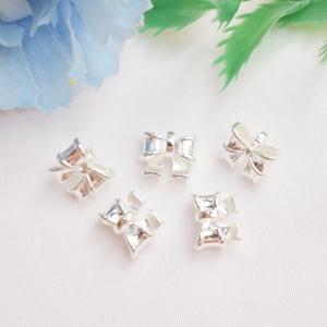 Five shiny silver bow pendants for DIY jewelry making and bracelet charms decoration