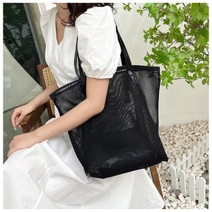 Close-up of black mesh hollow tote bag with a spacious interior for summer travel