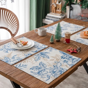 Christmas placemat with vintage blue floral prints on wood dining table
