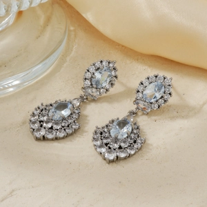 Elegant silver earrings with light blue oval gemstones and sparkling diamond accents