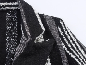 Detail of black and white striped boucle wool fabric showing the texture and collar detail