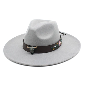 Detail view of ethnic fedora hat with bull head buckle and floral embroidery