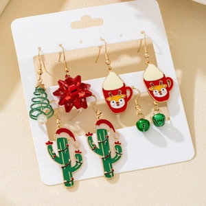 Macro shot of a Christmas earring set featuring festive tree, reindeer, and cactus charms