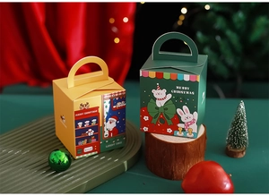 Close-up of yellow and green Christmas gift boxes with Santa and polar bear motifs