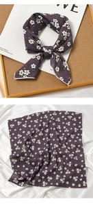 Detailed view of the purple floral cotton linen scarf with elegant rolled edges