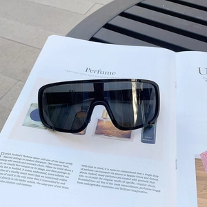 Detail of black sports cycling sunglasses with matte frame on a fashion magazine