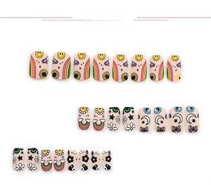 Detail of 24pcs pink press-on nails with cute rainbow and smiley face cartoon designs