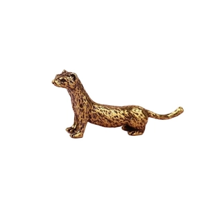 Brass lynx figurine with detailed fur texture standing on white background