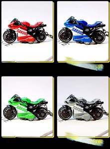 Detail showing colorful mini motorcycle keychains in red, blue, green, and grey finishes
