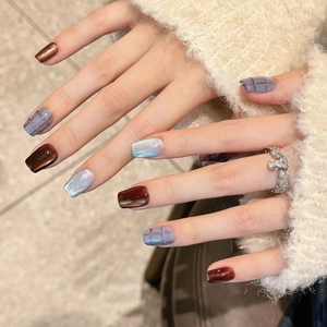 Handcrafted British style press-on nails featuring blue plaid and cat-eye brown design