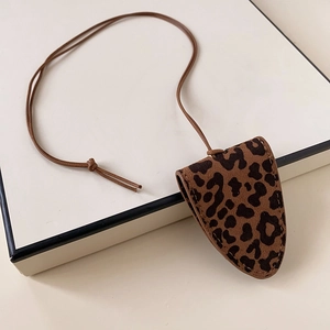 Detail of leopard print faux suede glasses case necklace with magnetic closure