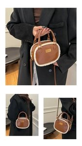 Detail of brown PU leather pillow bag with white plush trim and detachable strap