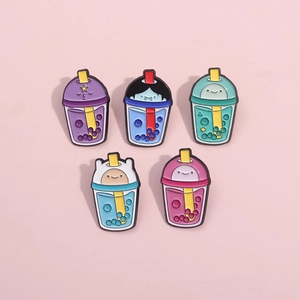 Close-up of five enamel pins shaped like Adventure Time character bubble tea cups