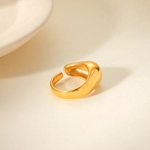 Close-up of golden chunky croissant ring with a polished mirror finish and adjustable band