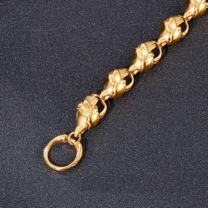 Macro shot of punk style golden skull pendant and stainless steel OT buckle chain
