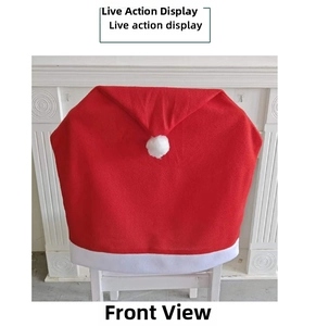 Detailed view of red velvet Christmas chair cover with white plush pompom and trim