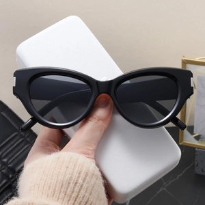 Detail of vintage cat-eye sunglasses with silver metal rivets and grey lenses
