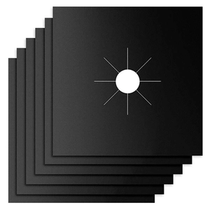 Stack of black heat-resistant Teflon gas stove liners with pre-cut center hole and texture