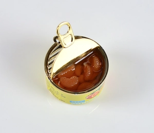 Detailed view of an open miniature orange tin can with realistic fruit flesh model
