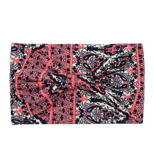 Detail of bohemian floral print headband with central knot design and elastic fabric