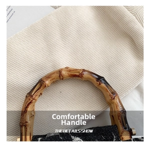 Detailed close-up of natural bamboo handle on a vintage-style plaid canvas handbag