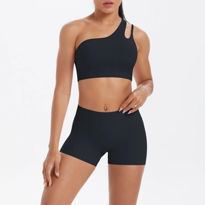 Detail of black one-shoulder yoga sports bra with hollow cutout and matching high waist shorts