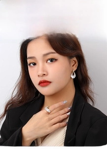 Close-up of retro S925 silver ring and earrings with white mother of pearl inlay