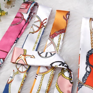 Elegant silk scarves with nautical anchor prints on soft white faux fur background