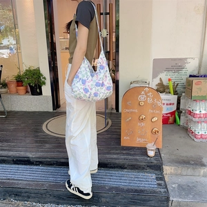 Detail of floral canvas hobo bag with large capacity and wide strap for daily wear