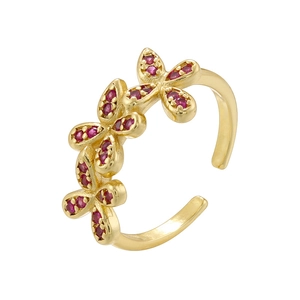 Detail of gold butterfly ring with ruby stones on white background showing fine jewelry design
