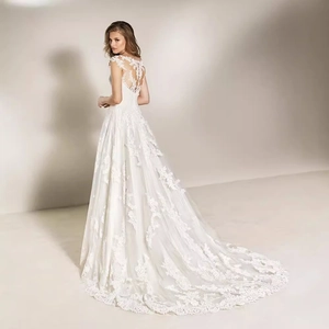 Elegant white lace wedding dress with V-neck and a long cathedral train back view