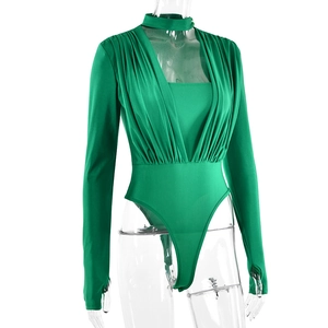 Close-up of green V-neck bodysuit with pleated texture, choker, and thumbholes